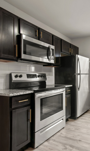 updated kitchen with granite countertops and stainless steel appliances.