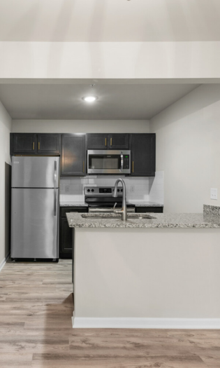 updated kitchen with granite countertops and stainless steel appliances.