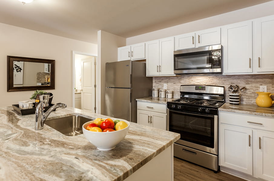 Updated Kitchen, with granite counter-tops, white cabinets, and new appliances