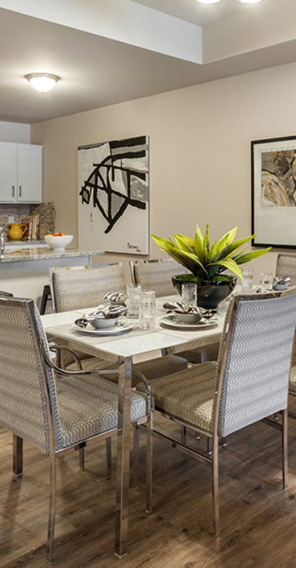 updated dining area with 6 chairs. Kitchen visible in the background